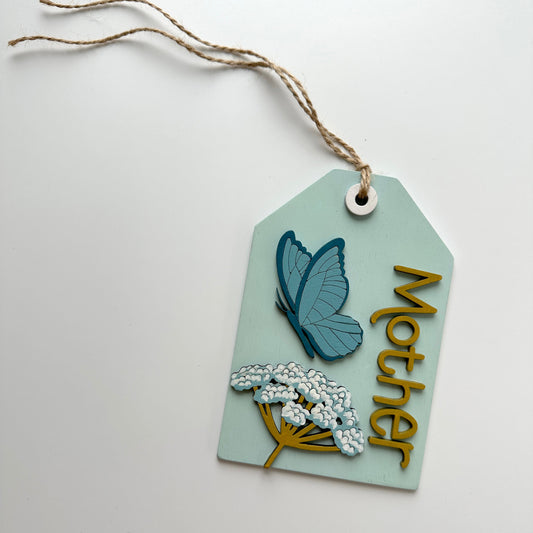 Decorative tag with butterfly and flowers design on a white background