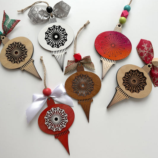 Decorative Christmas ornaments with intricate designs on a white background