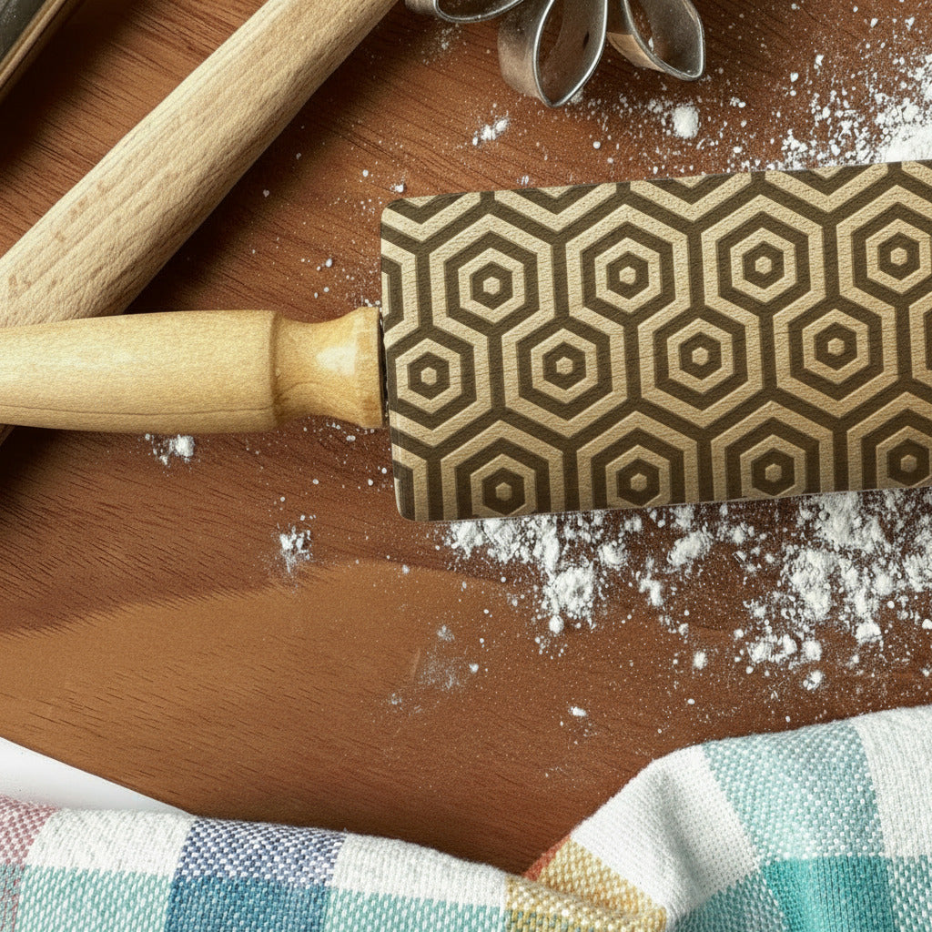 Rolling pin with geometric pattern on a wooden surface with flour, branded 'PickleandPeachStudio'.