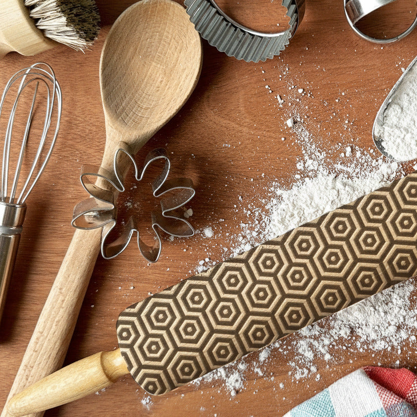 Wooden kitchen utensils with rolling pin and flour on a wooden surface, featuring 'PickleandPearcStudio' branding.