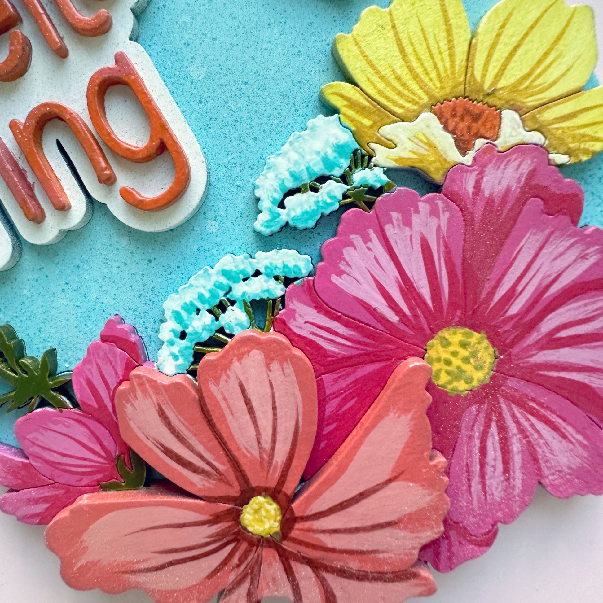 Colorful floral cookies with decorative icing on a blue background