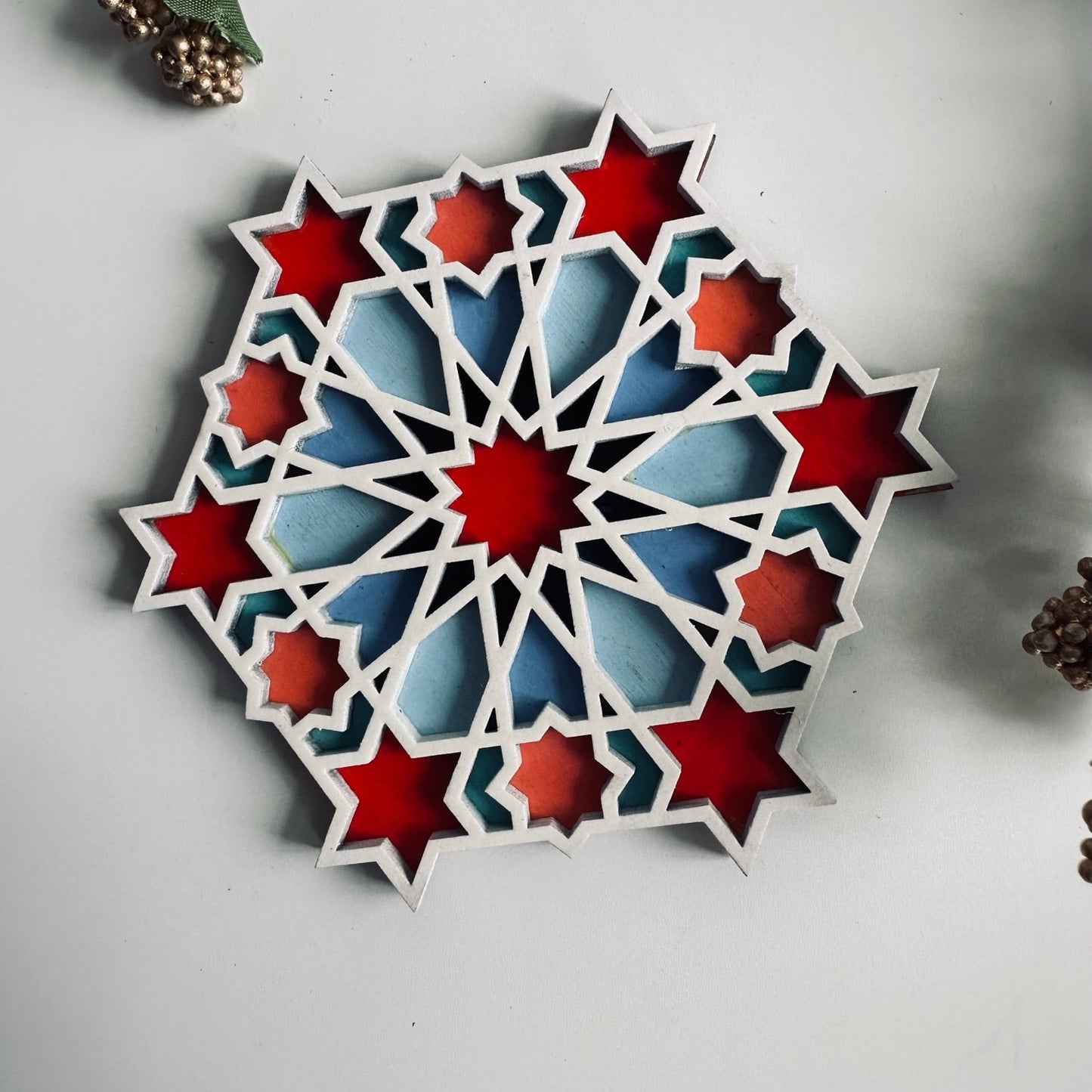 Decorative coaster with geometric star pattern on a light gray background
