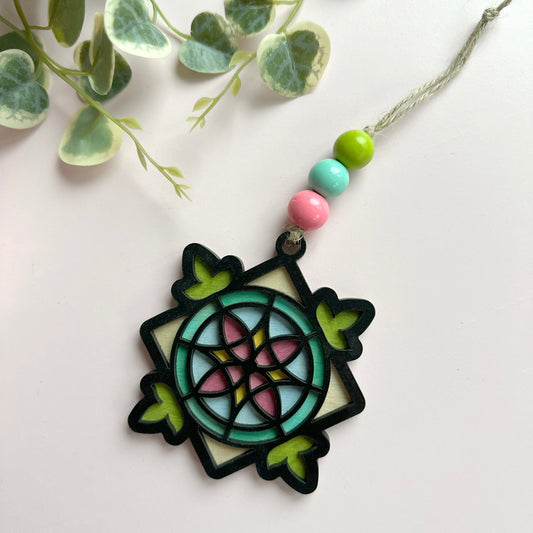 Decorative ornament with colorful beads on a white background