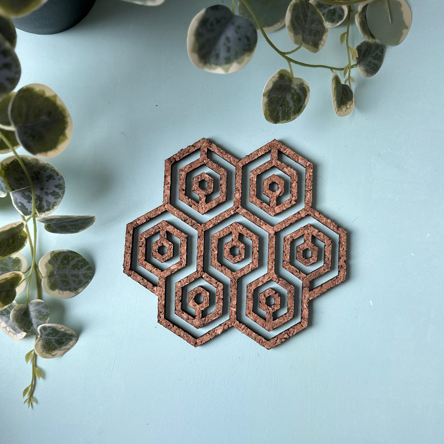 A honeycomb trivet on a light background