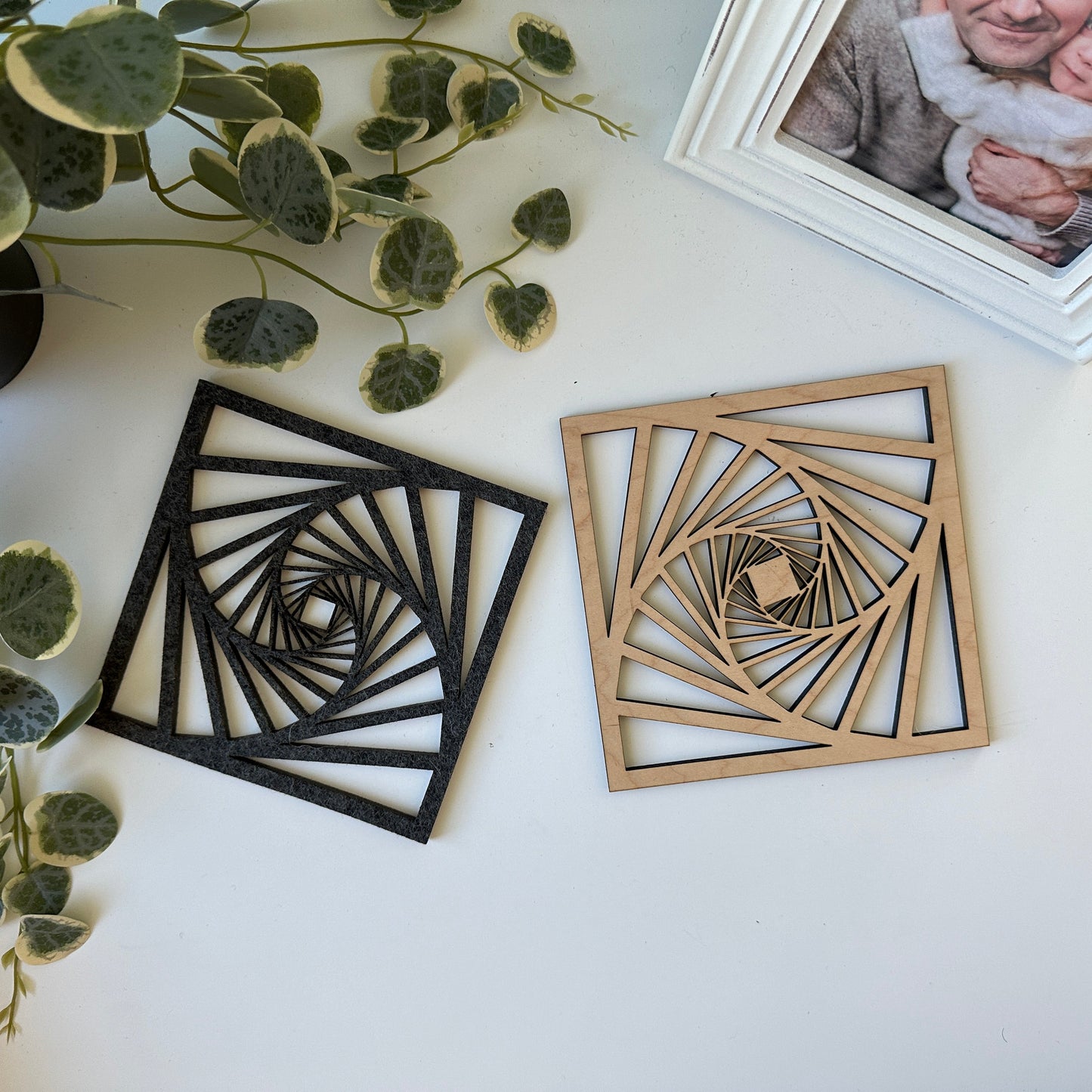 Laser-cut trivets with a decorative design on a light background
