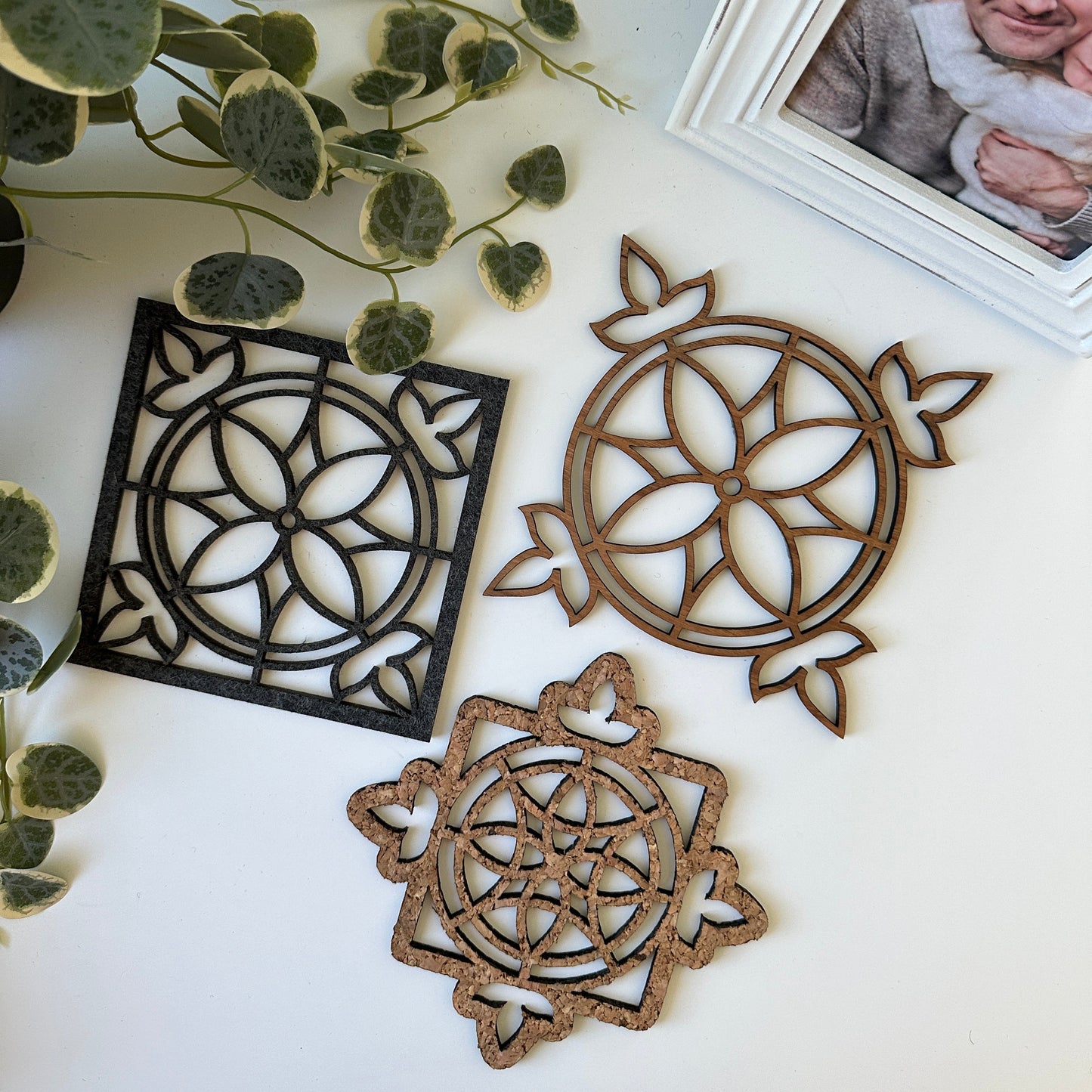 Three trivets with a stained glass design on a light background
