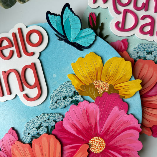 Colorful floral and butterfly design with 'Happy Mother's Day' text on a light blue background.