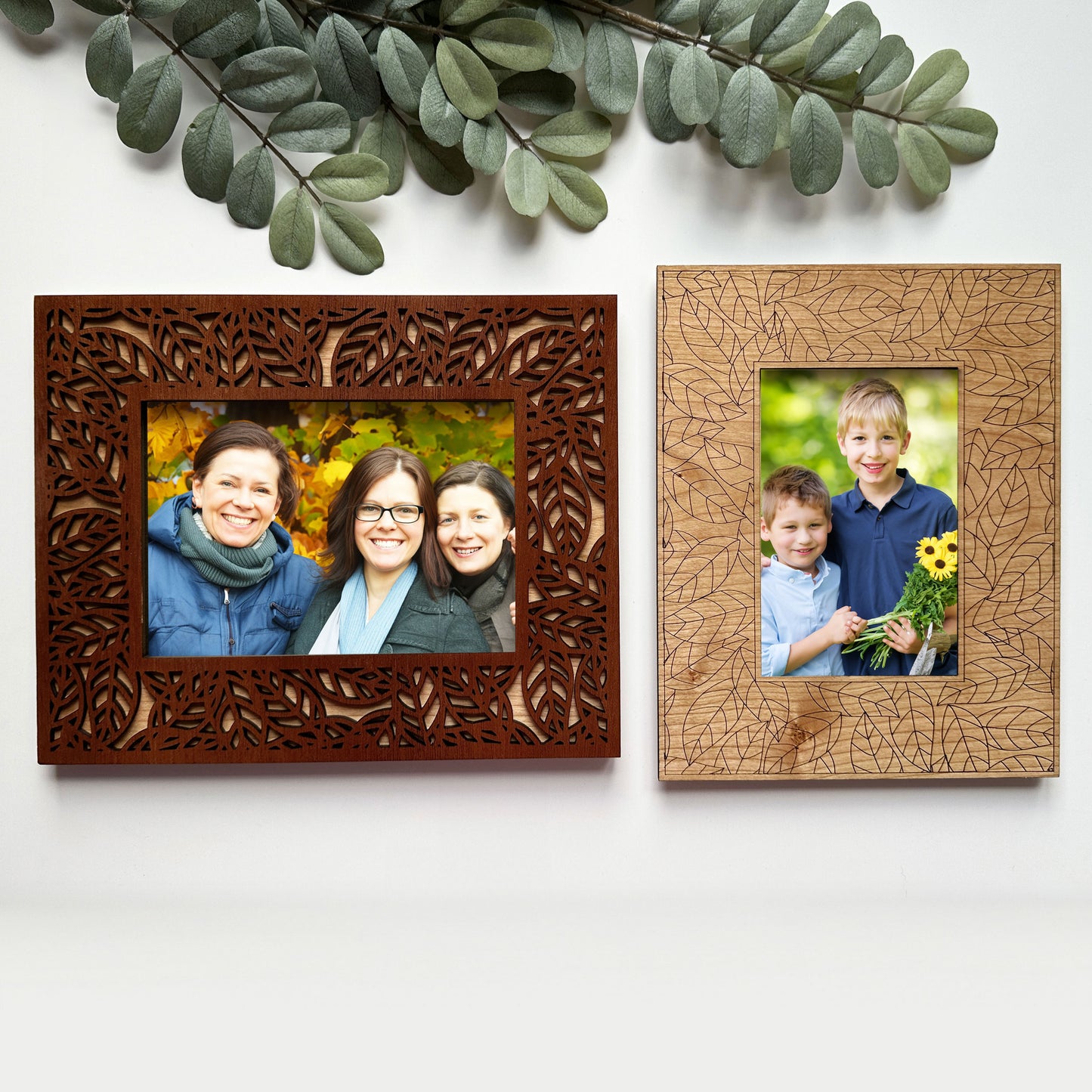Two wooden photo frames with family photos on a white background