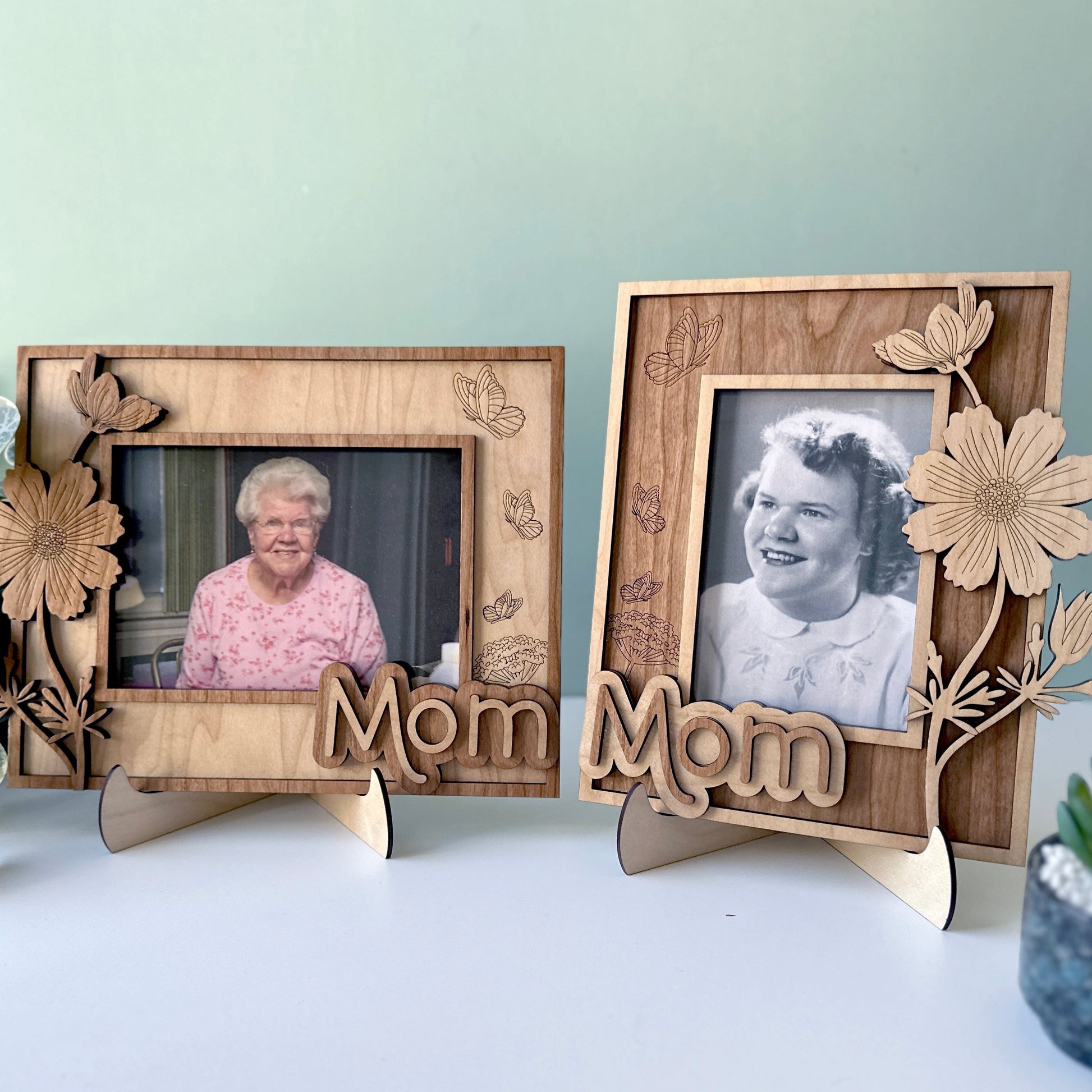Two wooden photo frames with floral designs and 'Mom' text, displaying black and white photos of an elderly woman.