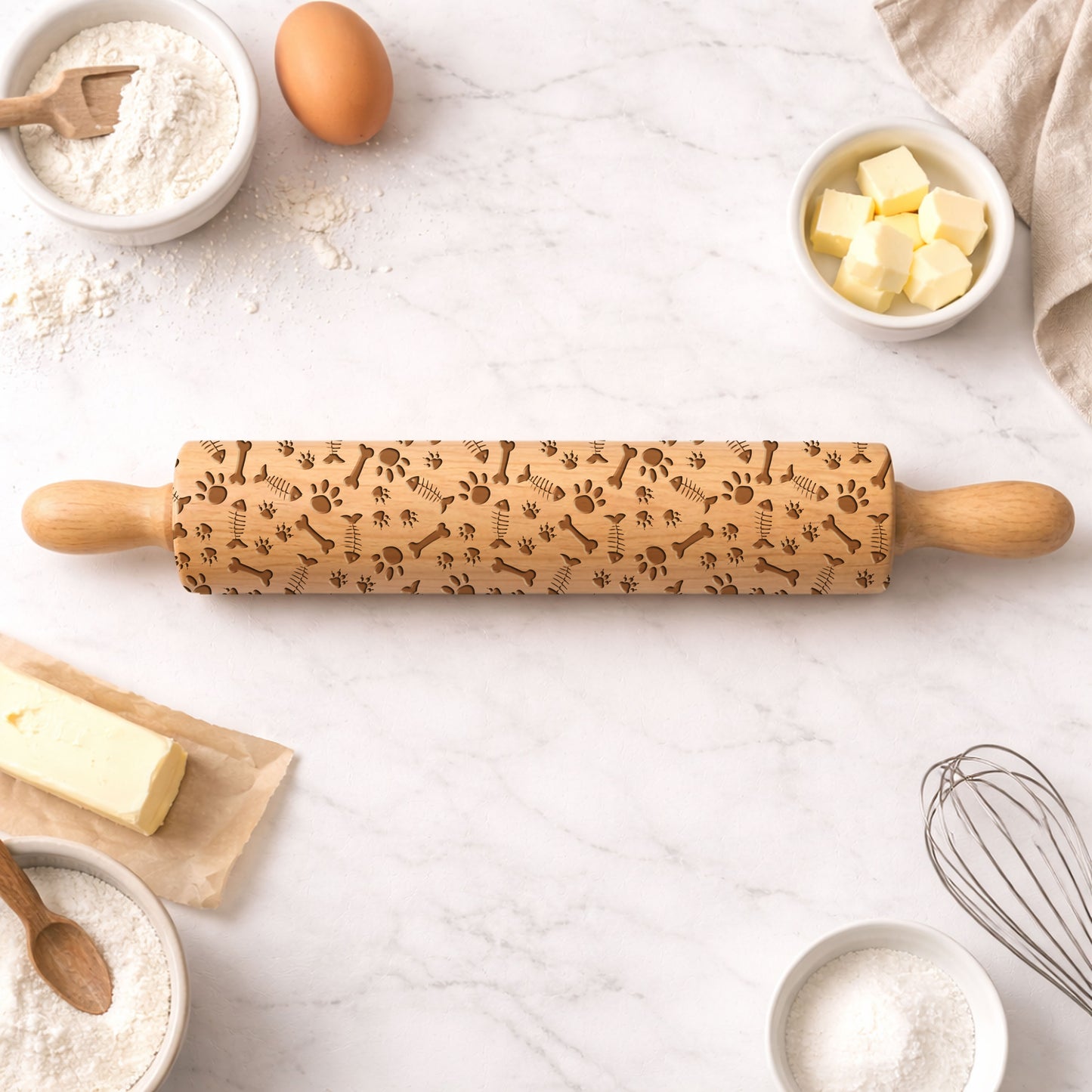 Decorative rolling pin with embossed patterns on a kitchen counter with baking ingredients.
