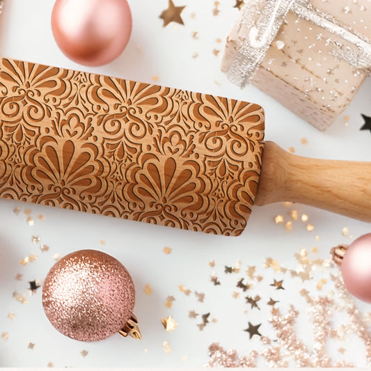 Decorative rolling pin with intricate patterns on a festive background with ornaments and confetti.