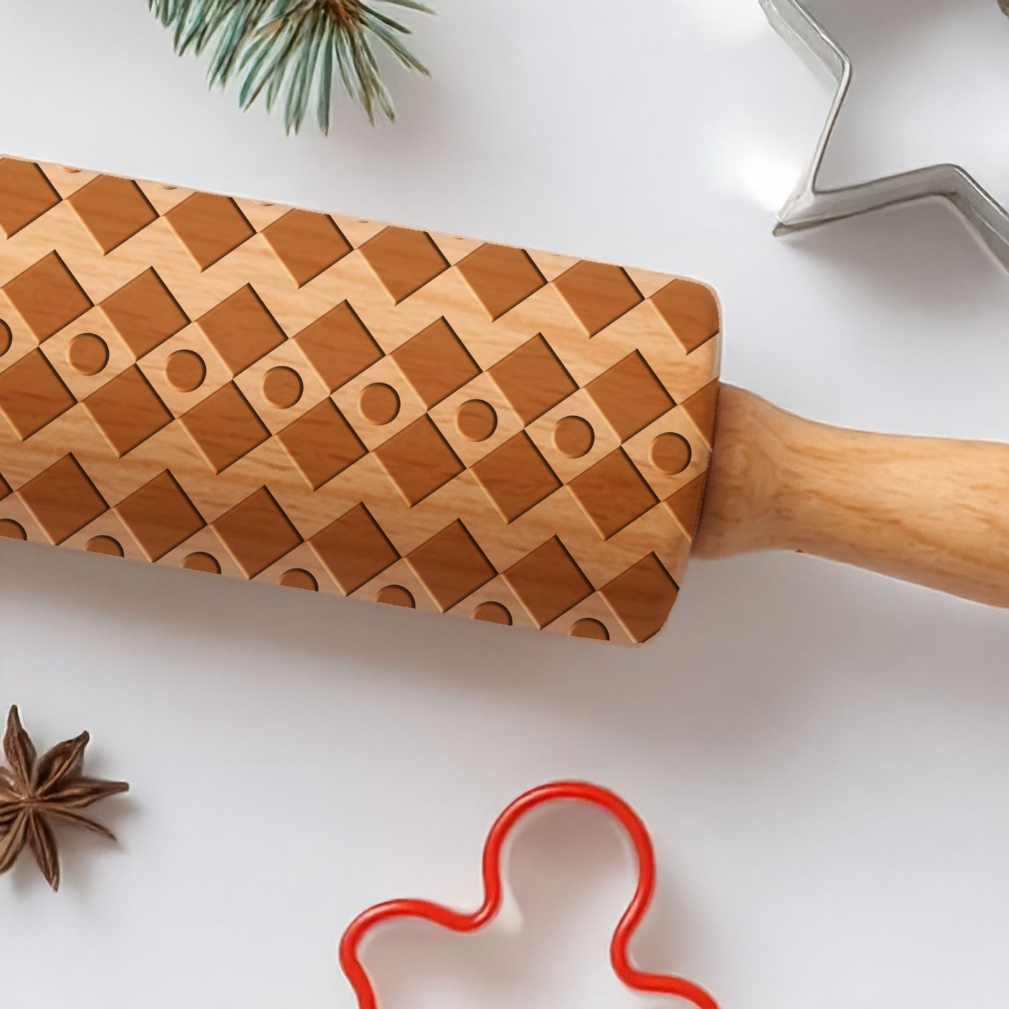 Wooden cookie cutter with geometric pattern on a white surface with star anise and red cookie cutter.