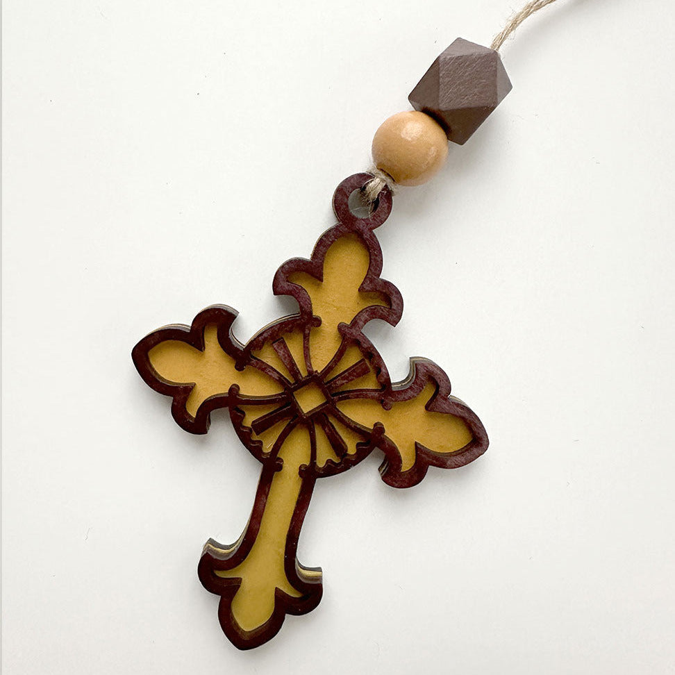 Decorative cross pendant with beads on a white background