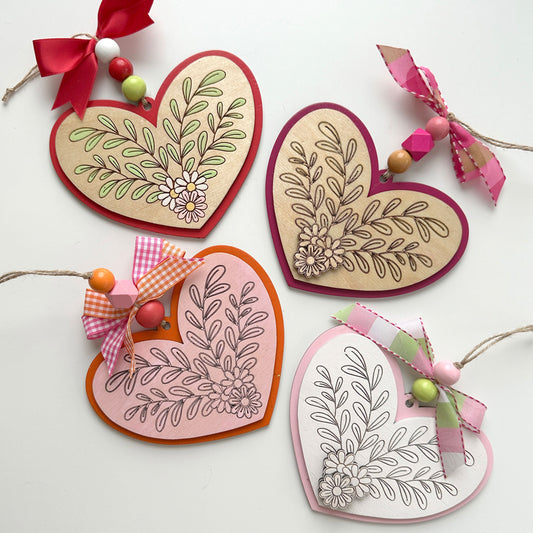 Heart-shaped decorative items with floral patterns on a white background