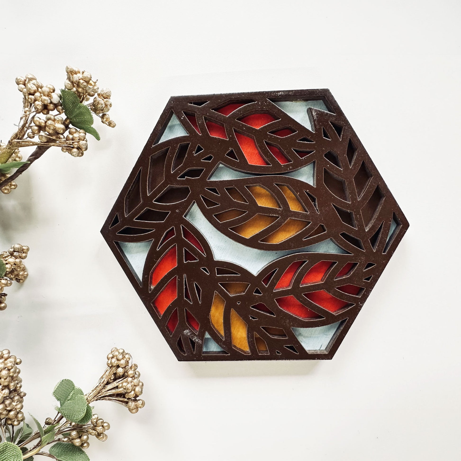 Decorative coaster with leaf pattern on a white background
