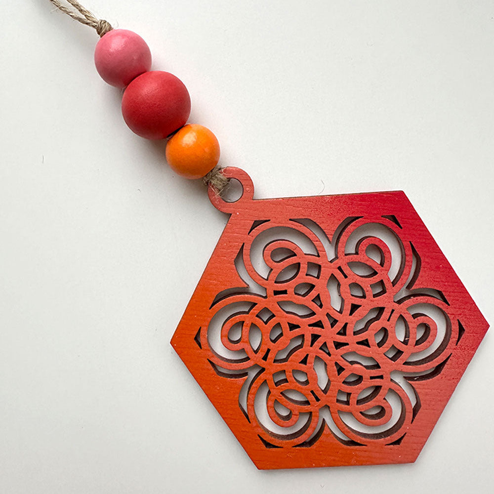 Decorative necklace with red and orange pendant on a white background