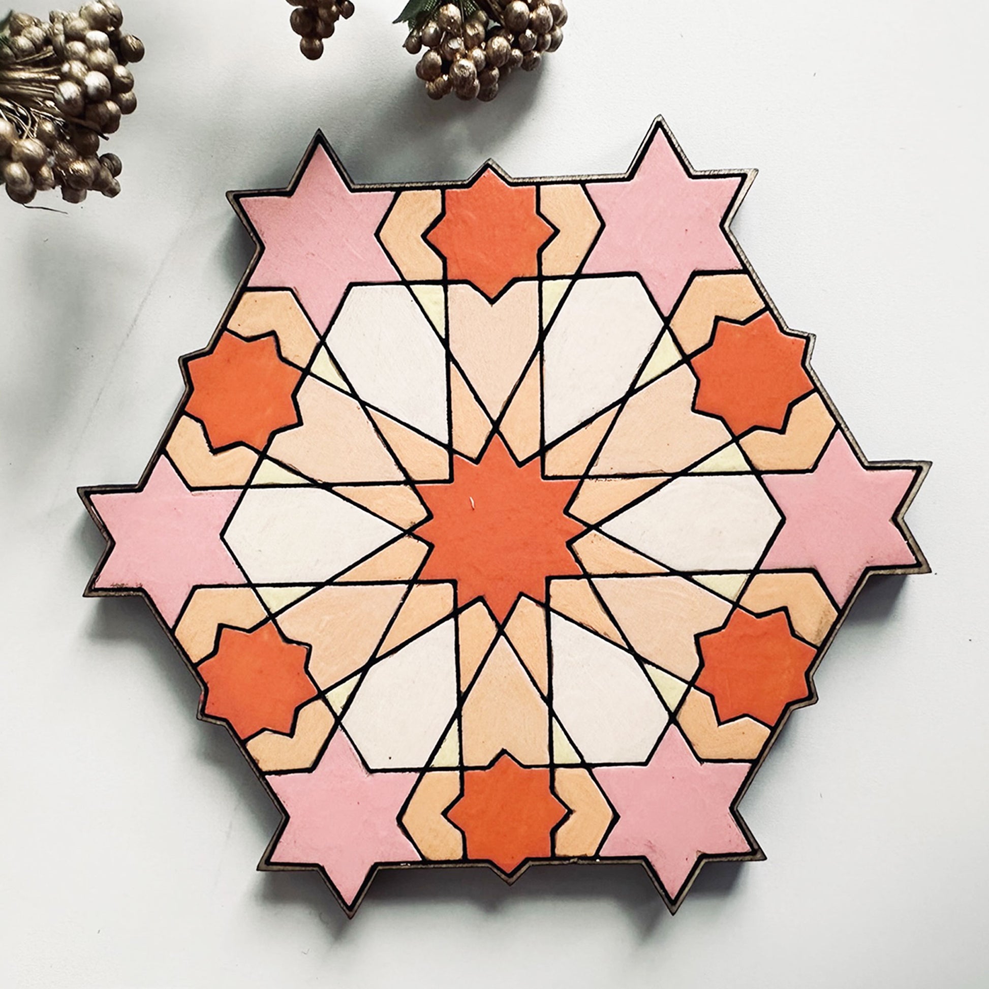 Geometric star pattern coaster on a white background